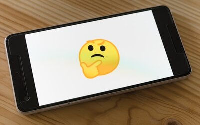 Schwarzes Smartphone mit gelbem Emoji eingeschaltet; Bild: Markus Winkler auf Unsplash